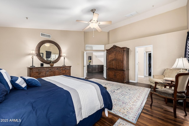 bedroom featuring a ceiling fan, dark wood-style flooring, visible vents, and baseboards