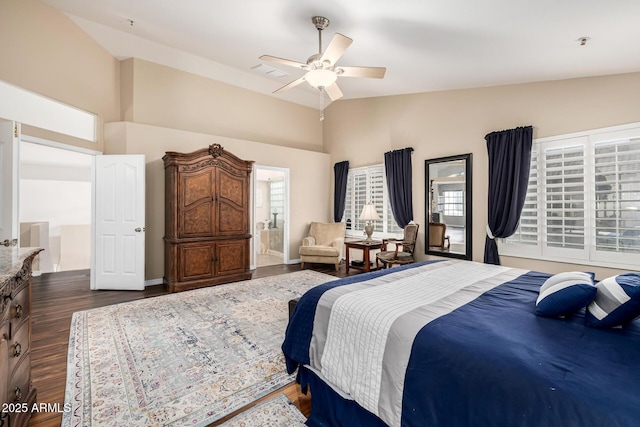 bedroom with ceiling fan, dark wood-style flooring, baseboards, vaulted ceiling, and ensuite bath