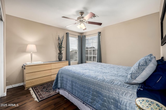 bedroom featuring dark wood-style floors, ceiling fan, and baseboards