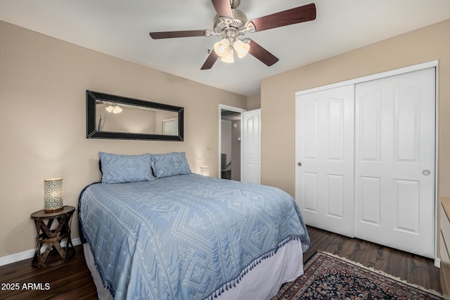 bedroom featuring ceiling fan, a closet, baseboards, and wood finished floors