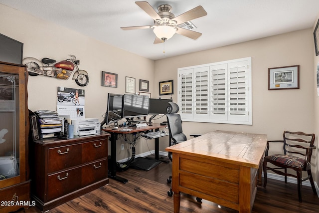 office space featuring dark wood-type flooring, a ceiling fan, and baseboards