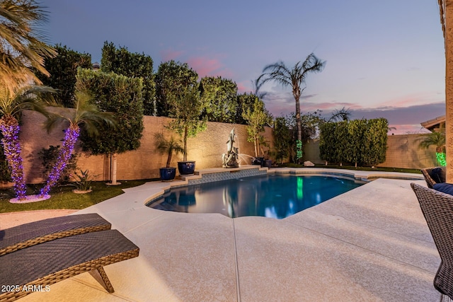 pool at dusk with a fenced in pool, a fenced backyard, and a patio