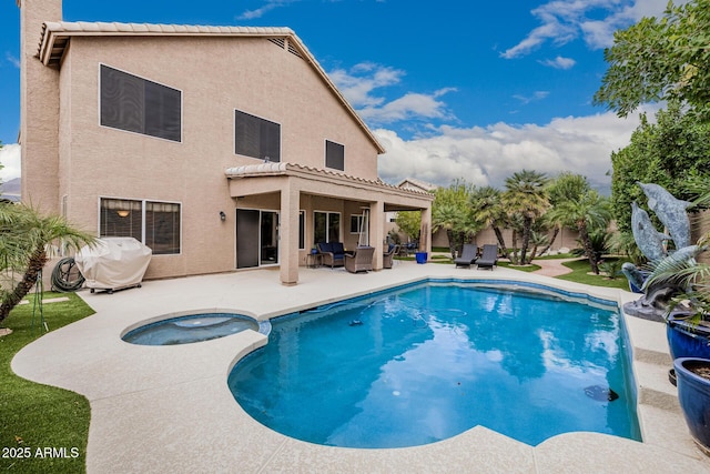 view of pool featuring a patio area, a fenced in pool, and an in ground hot tub