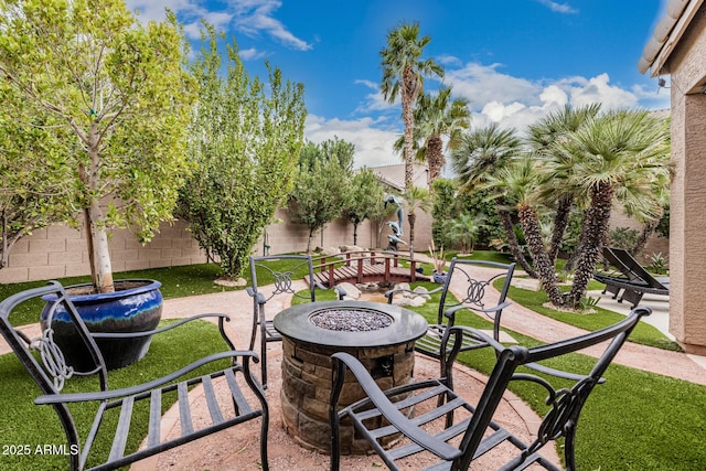 view of patio / terrace featuring an outdoor fire pit and fence