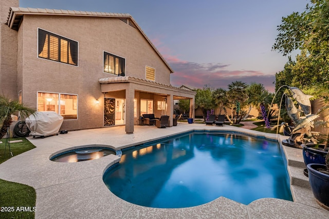 view of pool with a pool with connected hot tub, a patio area, outdoor lounge area, and area for grilling