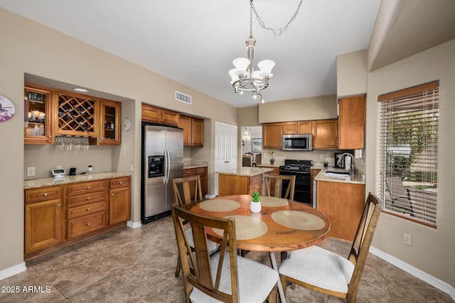 dining room featuring visible vents, a notable chandelier, and baseboards