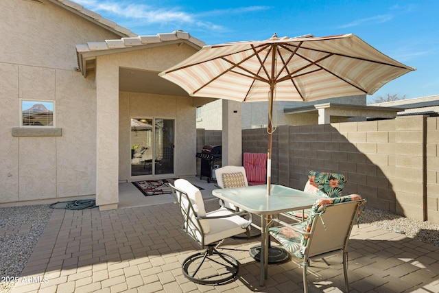 view of patio featuring a grill