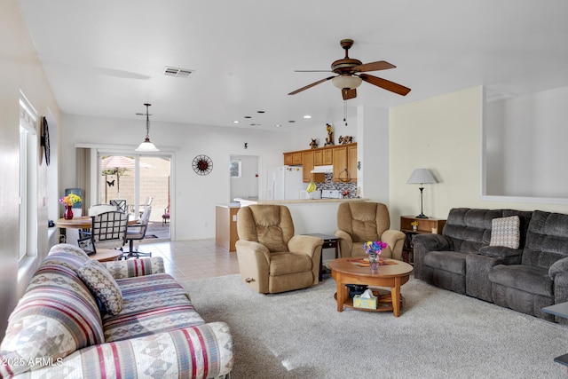 tiled living room with ceiling fan