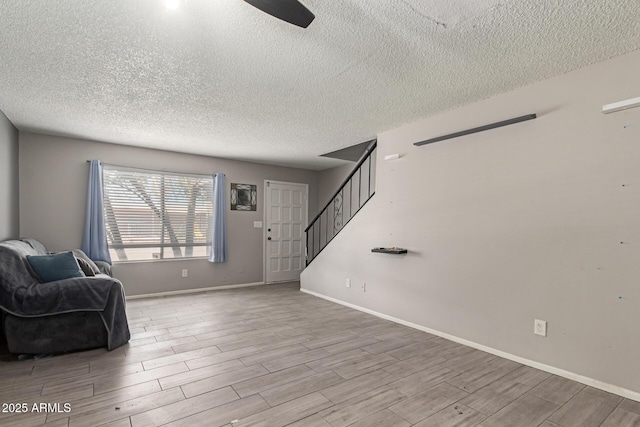 7126 N 19th Ave Unit 152, Phoenix, AZ 85021 - unfurnished room with a textured ceiling, stairway, and wood finished floors
