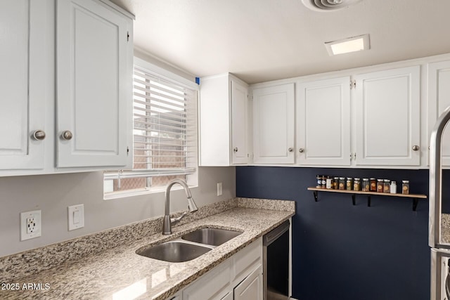 7126 N 19th Ave Unit 152, Phoenix, AZ 85021 - kitchen with dishwasher, white cabinets, and light stone counters
