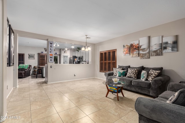 tiled living room featuring an inviting chandelier