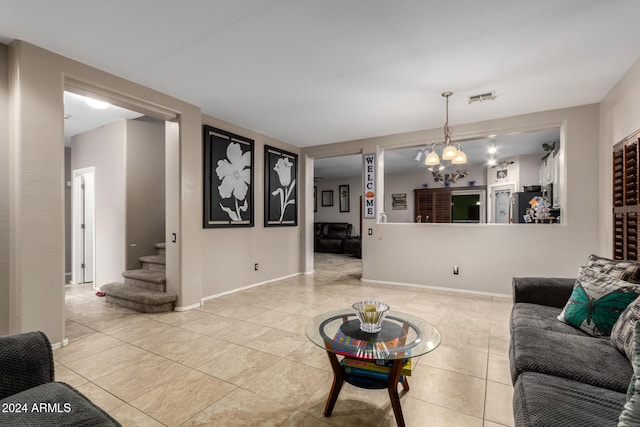 living room featuring a notable chandelier and light tile patterned flooring