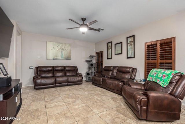 living room with light tile patterned floors and ceiling fan