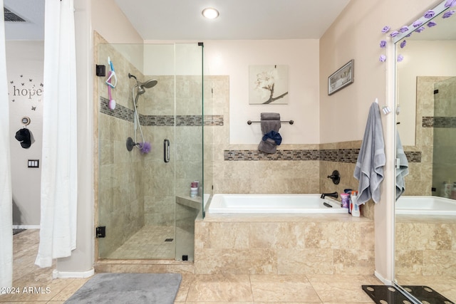 bathroom featuring plus walk in shower and tile patterned floors