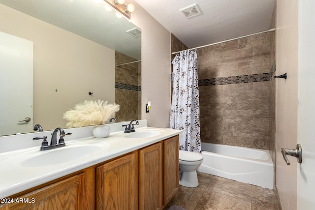 full bathroom featuring shower / tub combo, vanity, a textured ceiling, and toilet