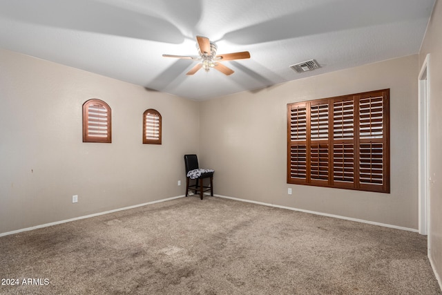 spare room with carpet flooring and ceiling fan