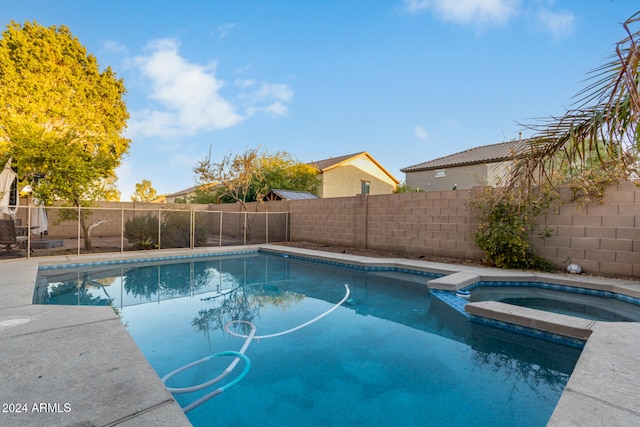 view of pool with an in ground hot tub