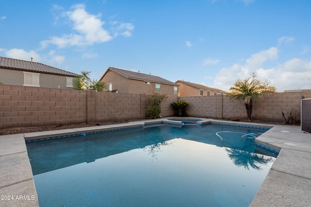 view of pool with an in ground hot tub