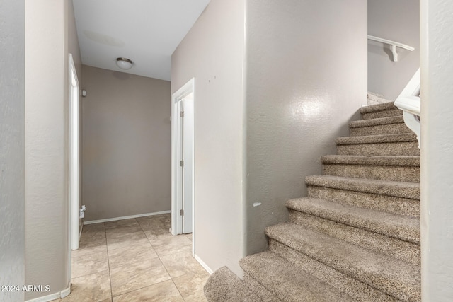 stairs with tile patterned floors