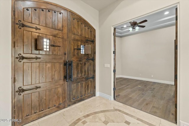 foyer featuring wood-type flooring and ceiling fan