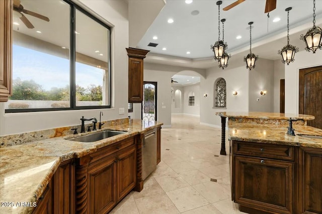 kitchen featuring pendant lighting, sink, dishwasher, and ceiling fan