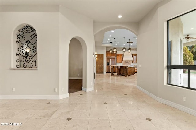 interior space with light tile patterned flooring and ceiling fan