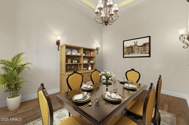 dining room featuring an inviting chandelier and dark hardwood / wood-style flooring