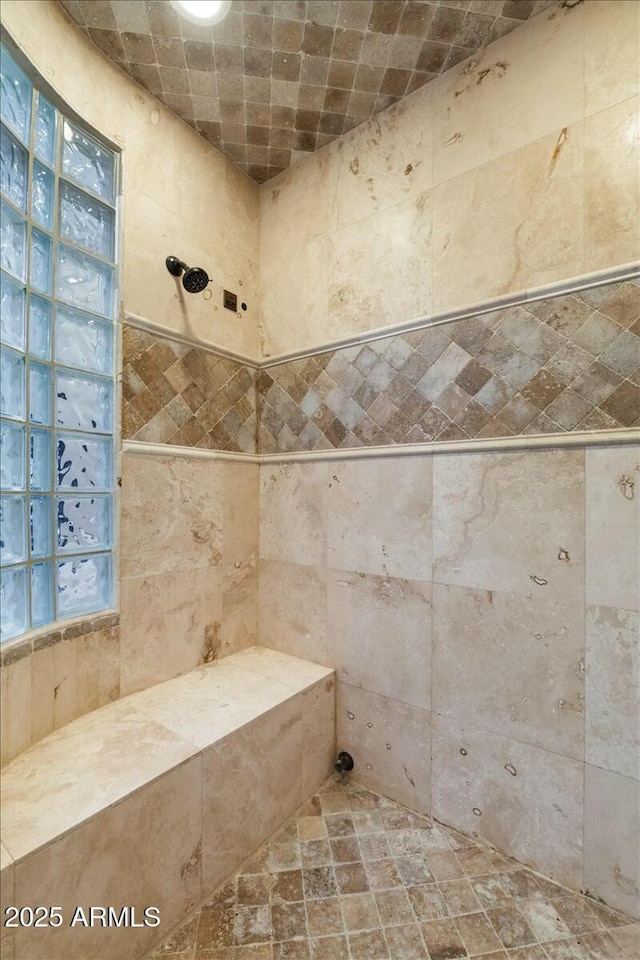 bathroom with a tile shower