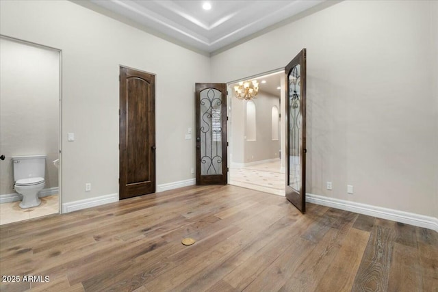 interior space featuring ensuite bath and light hardwood / wood-style floors