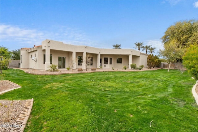 back of house featuring a lawn