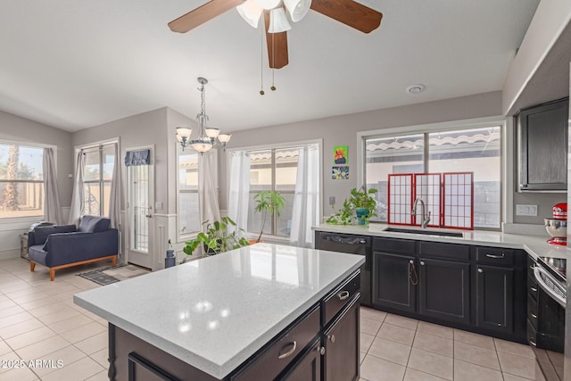 kitchen with plenty of natural light, a center island, sink, and electric range