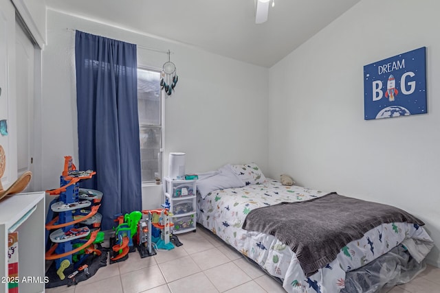 tiled bedroom featuring ceiling fan and a closet