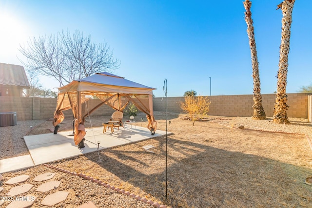 view of yard with a gazebo, central AC unit, and a patio