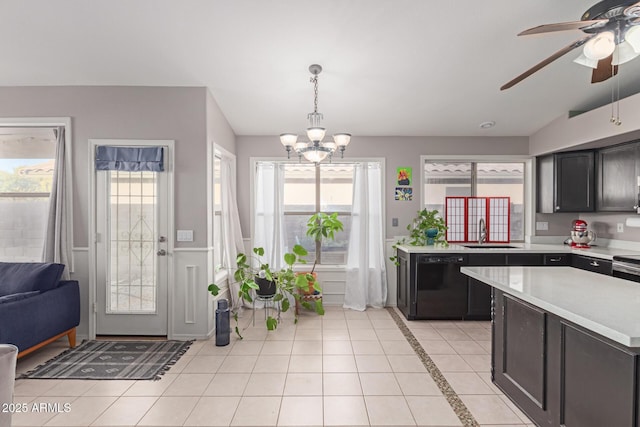 kitchen with hanging light fixtures, a wealth of natural light, black dishwasher, and sink