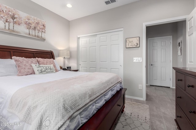 bedroom featuring light tile patterned floors and a closet