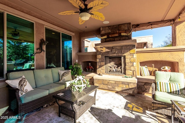 view of patio / terrace featuring an outdoor living space with a fireplace and ceiling fan