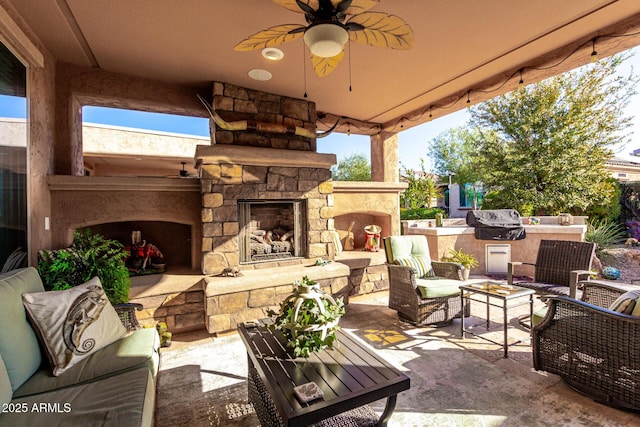 view of patio featuring an outdoor living space with a fireplace, ceiling fan, and a grill