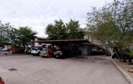 view of parking / parking lot featuring driveway and a carport