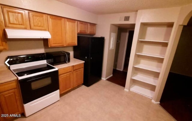 kitchen featuring freestanding refrigerator, under cabinet range hood, visible vents, light countertops, and electric range