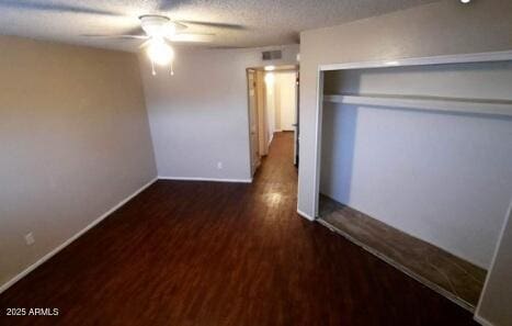 interior space with a closet, wood finished floors, a textured ceiling, ceiling fan, and baseboards