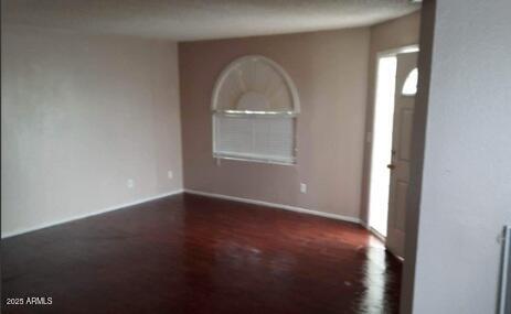 entryway featuring wood finished floors and baseboards