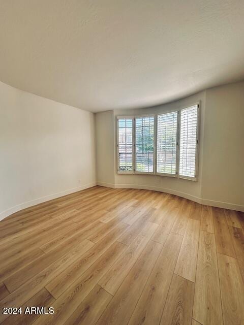 unfurnished room featuring light hardwood / wood-style floors