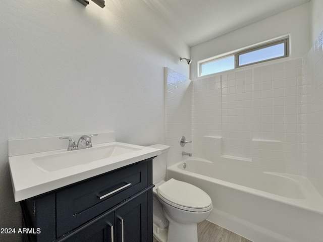 full bathroom with hardwood / wood-style floors, vanity, bathtub / shower combination, and toilet