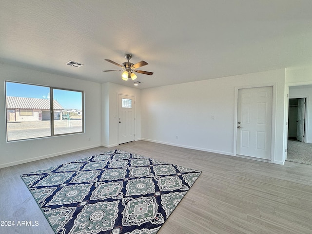 interior space featuring hardwood / wood-style flooring, ceiling fan, and a textured ceiling