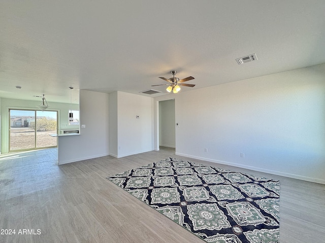 empty room with hardwood / wood-style flooring and ceiling fan