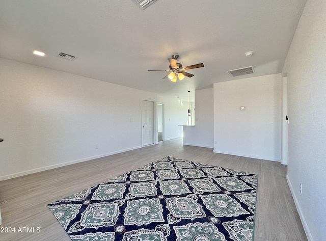 empty room with ceiling fan and wood-type flooring