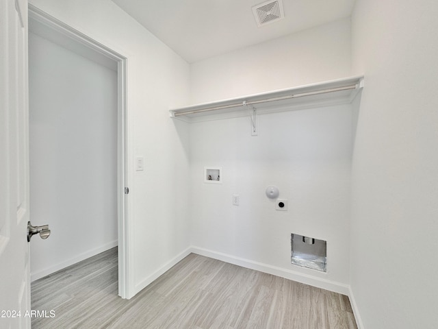 laundry area with washer hookup, light hardwood / wood-style floors, hookup for a gas dryer, and electric dryer hookup