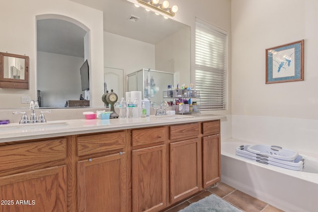 839 E Leo Pl, Chandler, AZ 85249 - full bath with double vanity, a shower stall, a bath, tile patterned floors, and ensuite bathroom