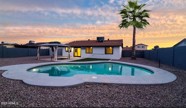 view of swimming pool featuring a fenced in pool, a patio area, a fenced backyard, and a gazebo