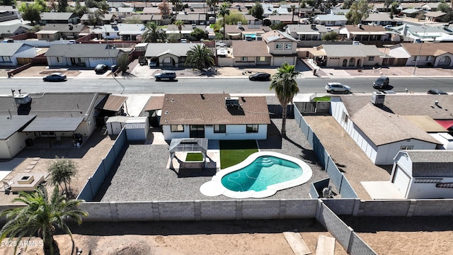 view of swimming pool featuring a residential view and a fenced backyard